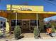 Bright and cheerful storefront with a vibrant yellow facade and outdoor seating area at 5300 Peachtree Rd # 0507, Atlanta, GA 30341