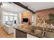 Bright and airy kitchen flowing into the living area with a brick accent wall at 5300 Peachtree Rd # 0507, Atlanta, GA 30341