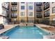 Exterior view of a refreshing community pool with fountains and surrounding lounge seating at 5300 Peachtree Rd # 0507, Atlanta, GA 30341