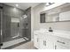 Bathroom features a gray tiled shower, white vanity, and decorative floor tiles at 5427 Fieldgreen Dr, Stone Mountain, GA 30088