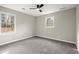 Bedroom featuring neutral colored walls, carpet, two large windows, and ceiling fan at 5427 Fieldgreen Dr, Stone Mountain, GA 30088