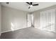 This bedroom features neutral walls, carpet flooring, and closet storage at 5427 Fieldgreen Dr, Stone Mountain, GA 30088