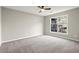 Neutral bedroom with carpeted floors and a large window at 5427 Fieldgreen Dr, Stone Mountain, GA 30088