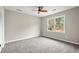 This bedroom features neutral walls, carpet flooring and a window at 5427 Fieldgreen Dr, Stone Mountain, GA 30088