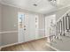 Inviting foyer with white front door, decorative molding and staircase with iron railings at 5427 Fieldgreen Dr, Stone Mountain, GA 30088