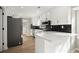 Modern kitchen with white cabinets, black backsplash, stainless steel appliances, and breakfast bar at 5427 Fieldgreen Dr, Stone Mountain, GA 30088