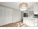 Eat-in kitchen featuring light wood floors, white cabinets and a view into the modern kitchen at 5427 Fieldgreen Dr, Stone Mountain, GA 30088