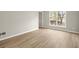 Bright living room featuring new light-colored, wide plank floors and neutral walls at 5427 Fieldgreen Dr, Stone Mountain, GA 30088