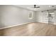 Large main bedroom featuring wood-look floors, ceiling fan, and a sliding barn door leading to the bathroom at 5427 Fieldgreen Dr, Stone Mountain, GA 30088