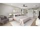 Spacious main bedroom featuring a ceiling fan, walk-in closet, and barn door to the ensuite bathroom at 5427 Fieldgreen Dr, Stone Mountain, GA 30088