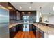 Modern kitchen boasts stainless steel appliances, granite countertops, and dark wood cabinetry at 1080 Peachtree Ne St # 1208, Atlanta, GA 30309