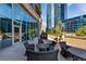 Relax on the private patio featuring comfortable seating surrounded by lush greenery at 1080 Peachtree Ne St # 1208, Atlanta, GA 30309