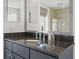 Modern bathroom vanity with dark granite countertop, mirror and vessel sink at 195 14Th Ne St # 2105, Atlanta, GA 30309