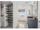 Well-organized bathroom with a granite countertop vanity, open shelving, and modern fixtures at 195 14Th Ne St # 2105, Atlanta, GA 30309