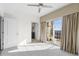 Bedroom with neutral carpet, ceiling fan, and sliding glass doors to a balcony at 195 14Th Ne St # 2105, Atlanta, GA 30309