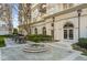 Elegant building exterior with manicured landscaping, a flower fountain, and outdoor seating area at 195 14Th Ne St # 2105, Atlanta, GA 30309