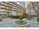 Picturesque courtyard with manicured greenery, an outdoor grill, dining sets and a central flower fountain at 195 14Th Ne St # 2105, Atlanta, GA 30309