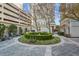 Picturesque courtyard featuring well-maintained landscaping, an outdoor grill, and a central water fountain feature at 195 14Th Ne St # 2105, Atlanta, GA 30309