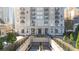 Grand building featuring elegant architecture, manicured landscaping, and a convenient parking entrance at 195 14Th Ne St # 2105, Atlanta, GA 30309