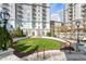 Beautiful high-rise building with a large grassy lawn and manicured landscaping at 195 14Th Ne St # 2105, Atlanta, GA 30309