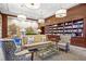 Cozy library with floor-to-ceiling bookshelves, plush seating, and decorative lighting at 195 14Th Ne St # 2105, Atlanta, GA 30309