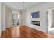 Bright living room with a fireplace, balcony access, and hardwood floors at 195 14Th Ne St # 2105, Atlanta, GA 30309