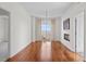 Bright living area featuring hardwood floors, a modern chandelier, and a glass door to a private balcony at 195 14Th Ne St # 2105, Atlanta, GA 30309