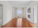 Bright living room featuring hardwood floors, fireplace, balcony, and chandelier at 195 14Th Ne St # 2105, Atlanta, GA 30309