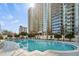 Outdoor pool with plenty of lounge chairs and high rise building in the background at 195 14Th Ne St # 2105, Atlanta, GA 30309