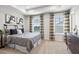 Bedroom with large windows, stylish furnishings, and decorative wall art at 3194 Eastham Run Dr, Dacula, GA 30019