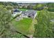 Aerial view of a large modern farmhouse with a lush green yard and backyard pond at 3735 Hamilton Mill Rd, Buford, GA 30519