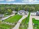 Expansive aerial view of a modern white and black home surrounded by lush greenery and neighboring properties at 3735 Hamilton Mill Rd, Buford, GA 30519