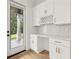 Modern bar area featuring white cabinets, wine rack, marble countertop, and a door to the outside at 3735 Hamilton Mill Rd, Buford, GA 30519