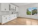 Modern bar area featuring white cabinets, wine rack, marble countertop, and natural lighting at 3735 Hamilton Mill Rd, Buford, GA 30519