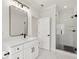 Bright bathroom features a modern vanity, sleek black hardware and frameless glass shower at 3735 Hamilton Mill Rd, Buford, GA 30519