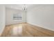 Bedroom with hardwood flooring, a modern ceiling fixture, and natural light from a window at 3735 Hamilton Mill Rd, Buford, GA 30519