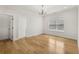 Bedroom with hardwood flooring, a modern ceiling fixture, and a doorway leading to another room at 3735 Hamilton Mill Rd, Buford, GA 30519