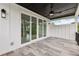 Covered patio features a dark ceiling, ceiling fan and large sliding glass doors at 3735 Hamilton Mill Rd, Buford, GA 30519