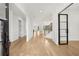 Bright foyer featuring hardwood floors, an open staircase, black-framed glass doors, and views of the kitchen at 3735 Hamilton Mill Rd, Buford, GA 30519