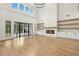 Open living room showcasing a modern fireplace, floor-to-ceiling windows and wood accents at 3735 Hamilton Mill Rd, Buford, GA 30519