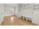 Mud room with built-in shelving, seating, and white cabinets at 3735 Hamilton Mill Rd, Buford, GA 30519