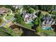 Aerial view of estate home with pool, pond and landscaped grounds in a luxury community at 938 Crescent River Pass, Suwanee, GA 30024