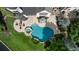 Aerial view of backyard with pool, spa, stone patio with lounge chairs and firepit at 938 Crescent River Pass, Suwanee, GA 30024