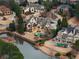 A beautiful aerial view showcasing the home, its landscaping, and a pond in a well-planned residential area at 938 Crescent River Pass, Suwanee, GA 30024