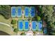 Aerial view of eight well-maintained tennis courts within a lush, green community setting at 938 Crescent River Pass, Suwanee, GA 30024