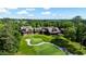 Elevated aerial view overlooking a large estate with golf course view, and lush landscape at 938 Crescent River Pass, Suwanee, GA 30024