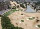 Aerial view of golf course and ponds with residential homes along the perimeter at 938 Crescent River Pass, Suwanee, GA 30024