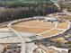 Aerial view of pedestrian bridge, parking, green space, and performance venue with access to retail and office space at 938 Crescent River Pass, Suwanee, GA 30024