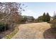 Backyard view with manicured lawn, trees and lake at 938 Crescent River Pass, Suwanee, GA 30024