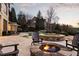 A backyard featuring a fire pit, lounge chairs, pool, and hot tub at 938 Crescent River Pass, Suwanee, GA 30024